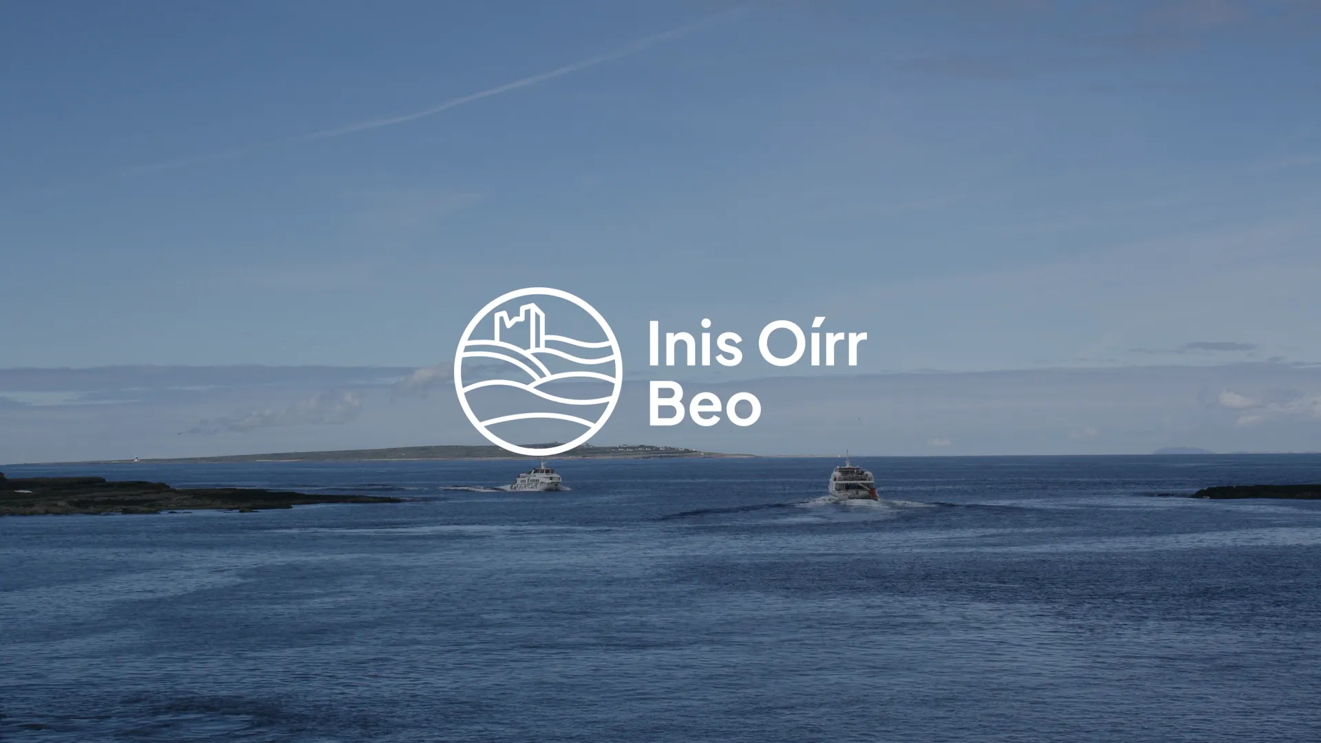 Báid farantóireachta ag trasnú an chaoil go hInis Oírr, le lógó Inis Oírr Beo